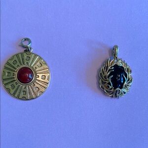 Two Gold-Tone Pendants. Rust Stone Sunburst Pendant, and Black Stone Nestled